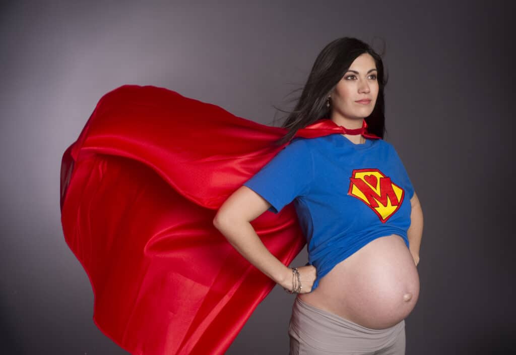 pregnant woman in superman outfit