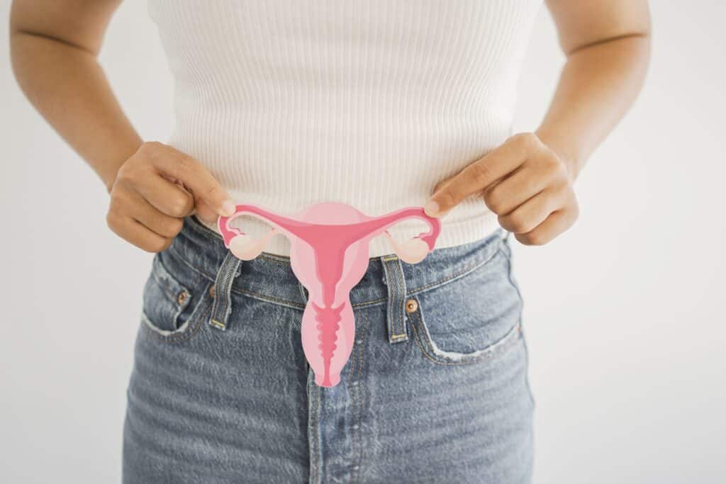 Emma Chamberlain opens up about learning of her PCOS at a hair salon | "Turns out she was an OBGYN and she diagnosed me with PCOS." Pregnancy News woman holding uterus