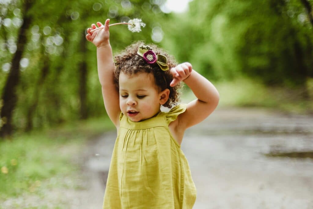 65+ Dazzling & Defiant D Names for Girls | The only two D girl names to crack the top-100 in 2024 were Delilah (50th) and Daisy (76th). Babies baby wearing green dress with dandelion in hand