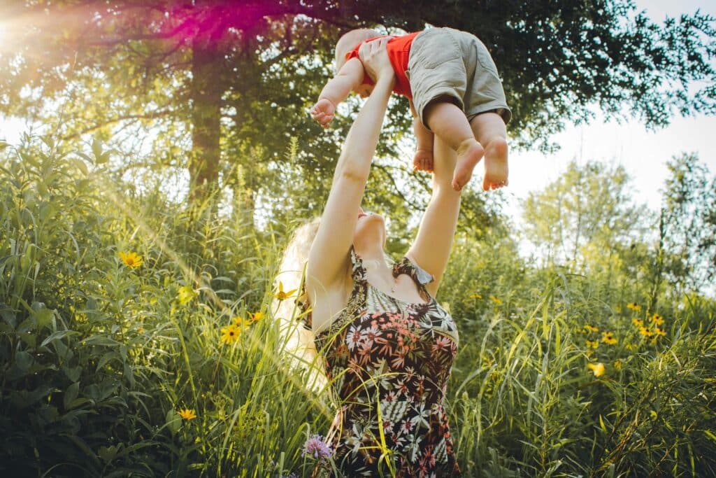 mother throwing baby in air