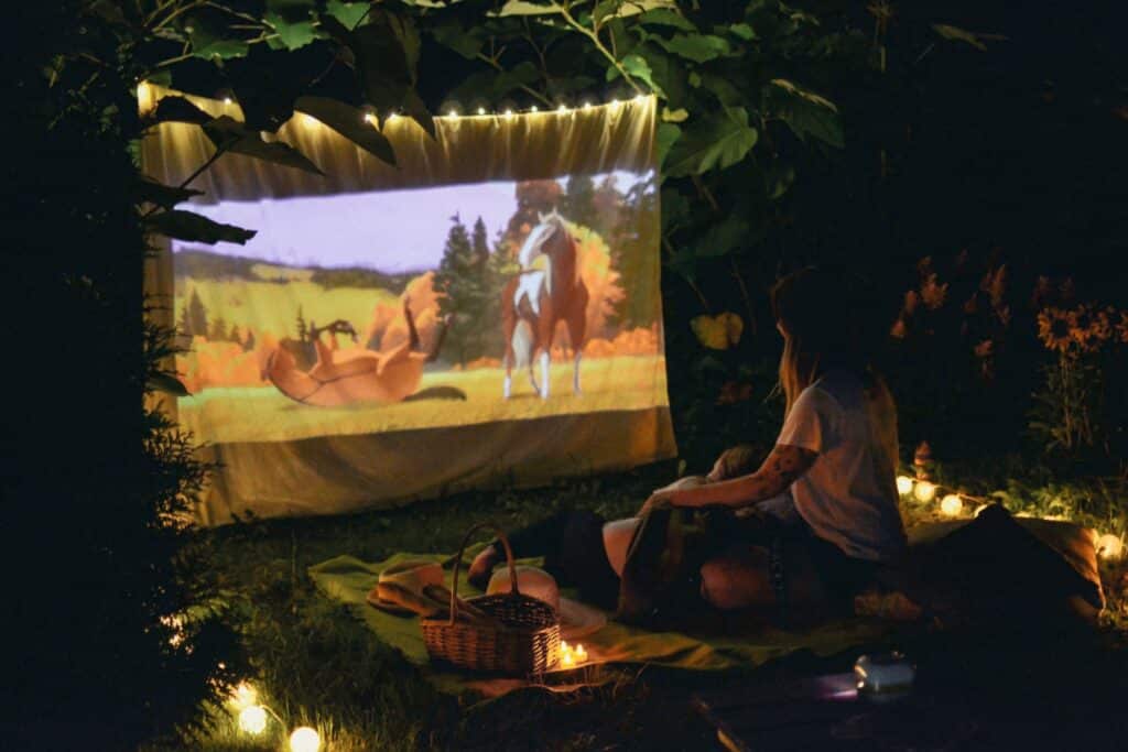 National Movie Night just got a lot better with these affordable family-friendly classics | National Movie Night is Friday, June 13th — and everyone in the family is invited! Lifestyle & Entertainment outdoor family movie night mother and son