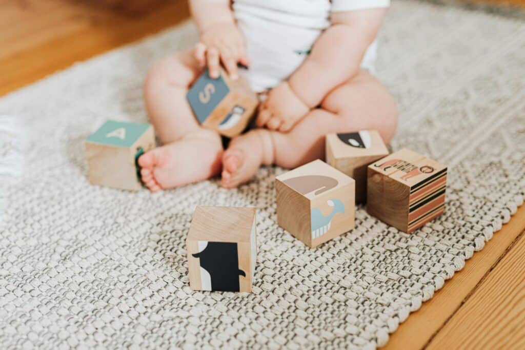 60+ Excellent Ideas for Baby Boy Names Beginning With E | Elijah, Ezra, Ethan and Elias were all top-25 boy names in the U.S. in 2024. Babies baby playing with wooden blocks