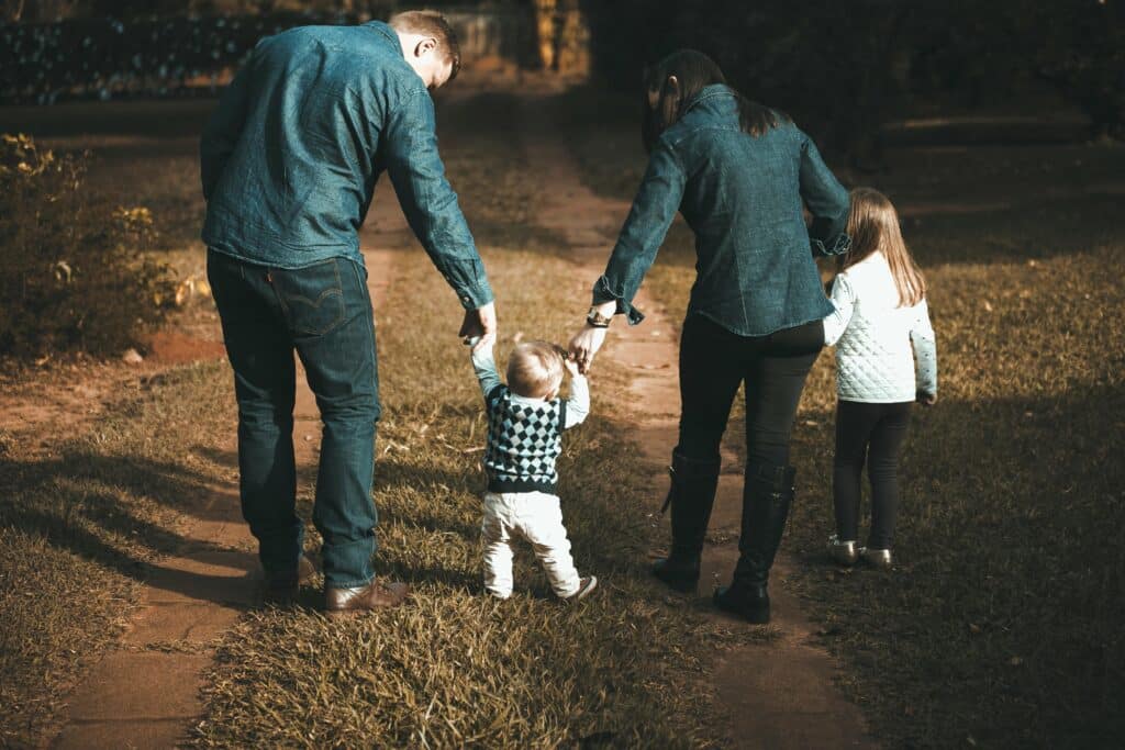 Simple yet meaningful ways kids can show appreciation on National Parents Day | Mark your calendars — because National Parents’ Day lands on Sunday, July 27. Parenting family of four walking holding hands