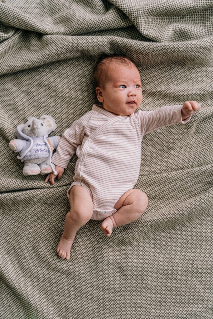baby boy laying down on bed