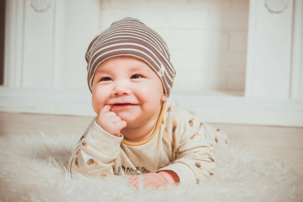 baby boy smiling into camera