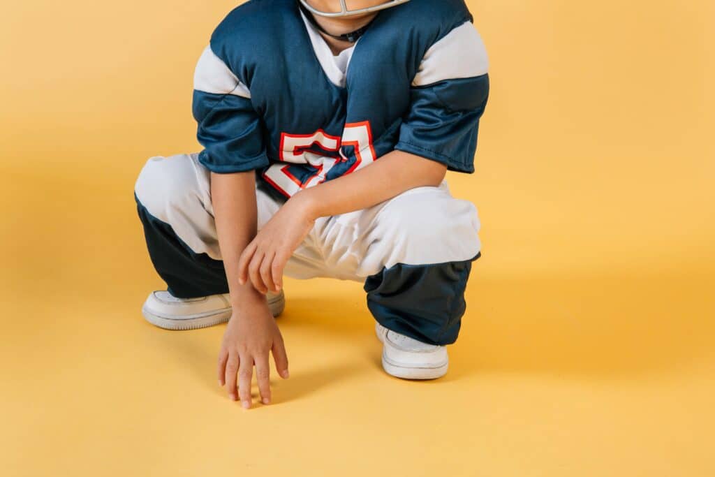 young boy in football pads
