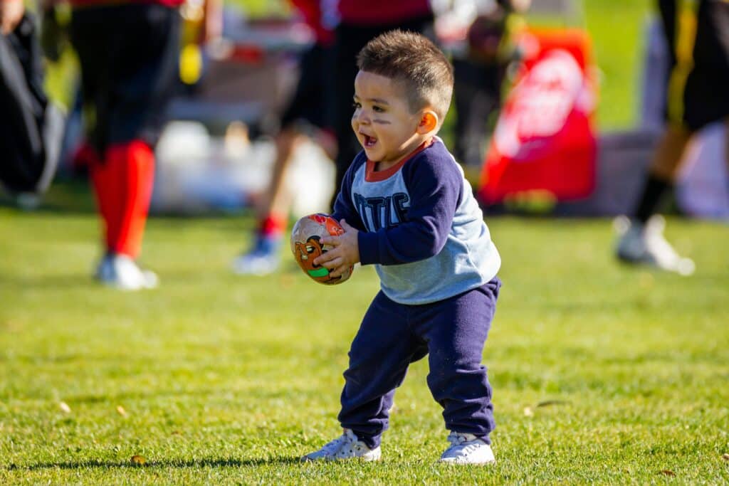 young boy playing football