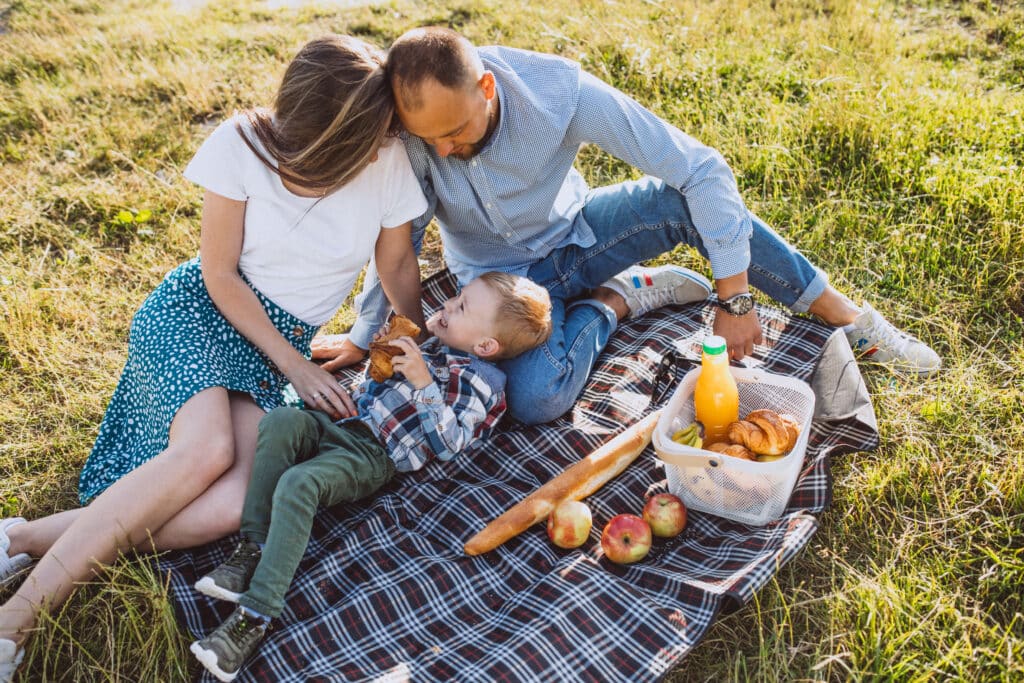 Adorable family picnic food ideas to celebrate National Eat Outside Day | National Eat Outside Day is almost here — and it’s the perfect excuse to round up the family for a picnic. Food a family enjoys a picnic with son
