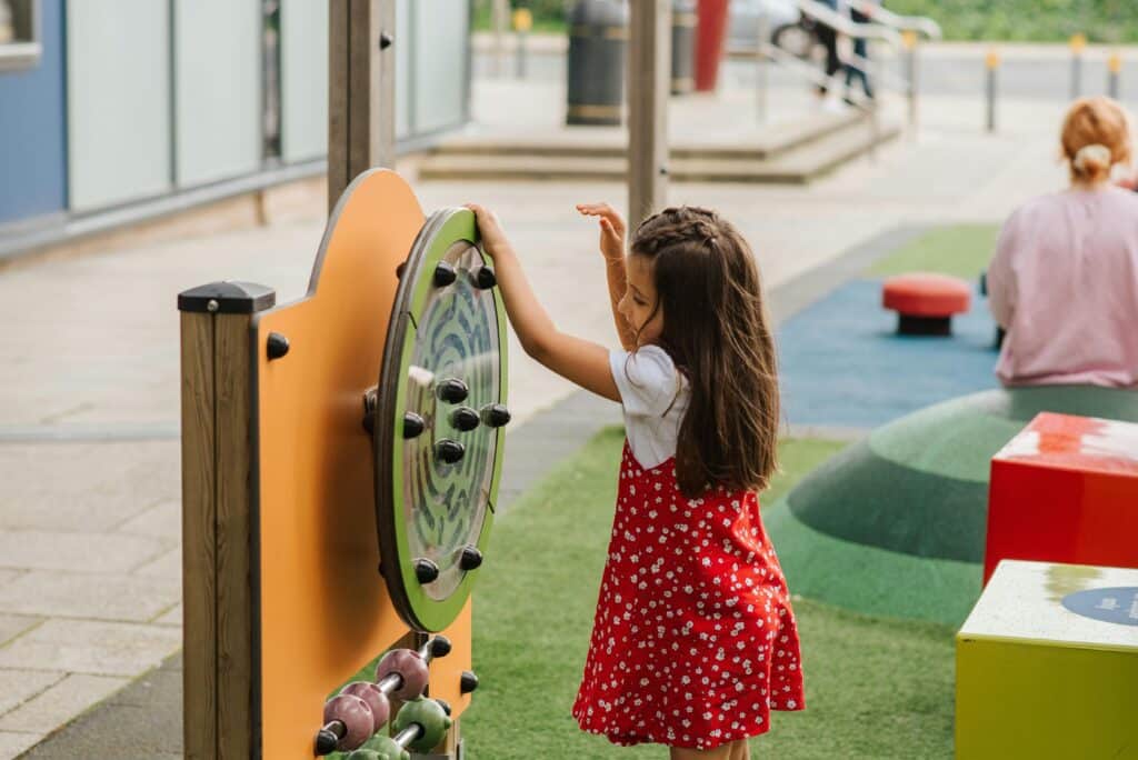 young girl playing alone at playground