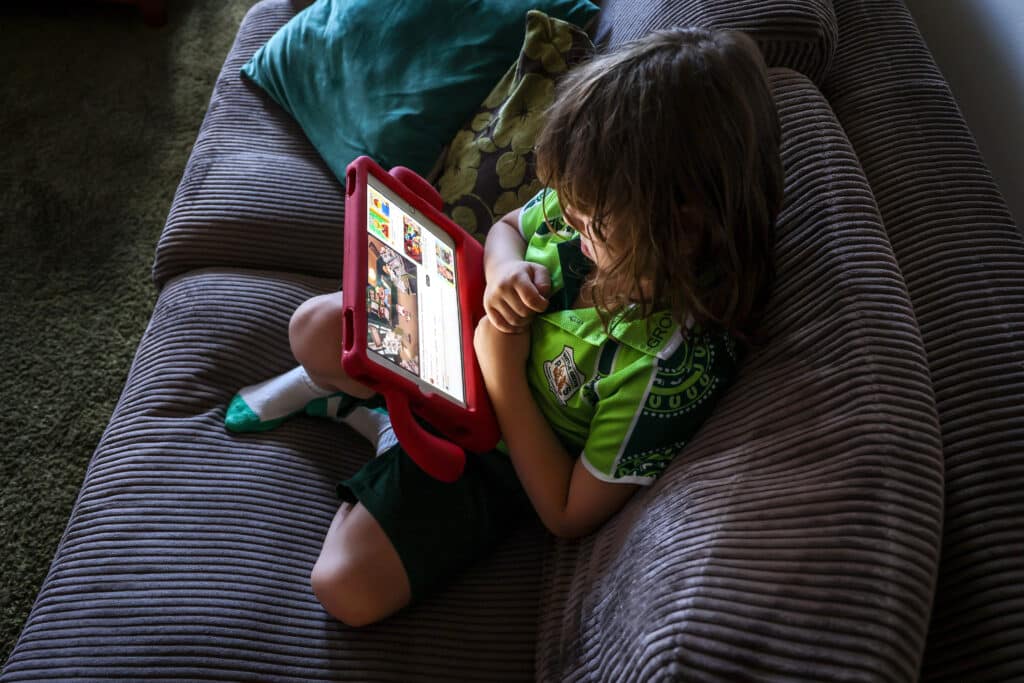 Is Modern TV Too Much? Here’s Why Parents Are Making the Switch to 90s Kids Shows 1 2243719032 young girl watching kids shows on tablet