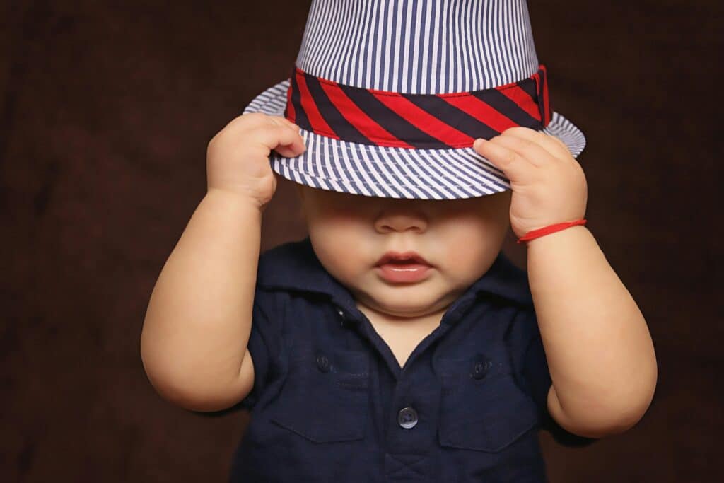 young boy wearing striped blue fedora mytholog names