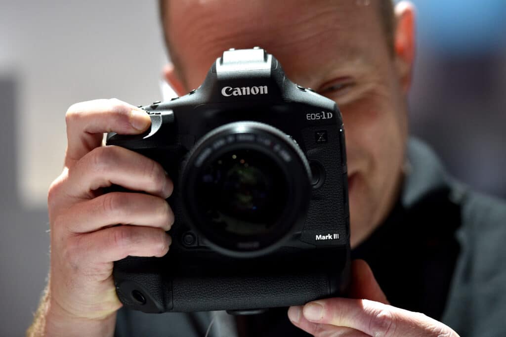 26 Nostalgic Sounds From Your Childhood That Kids Today May Never Hear Again 13 1198148583 man holding old canon camera nostalgic sounds