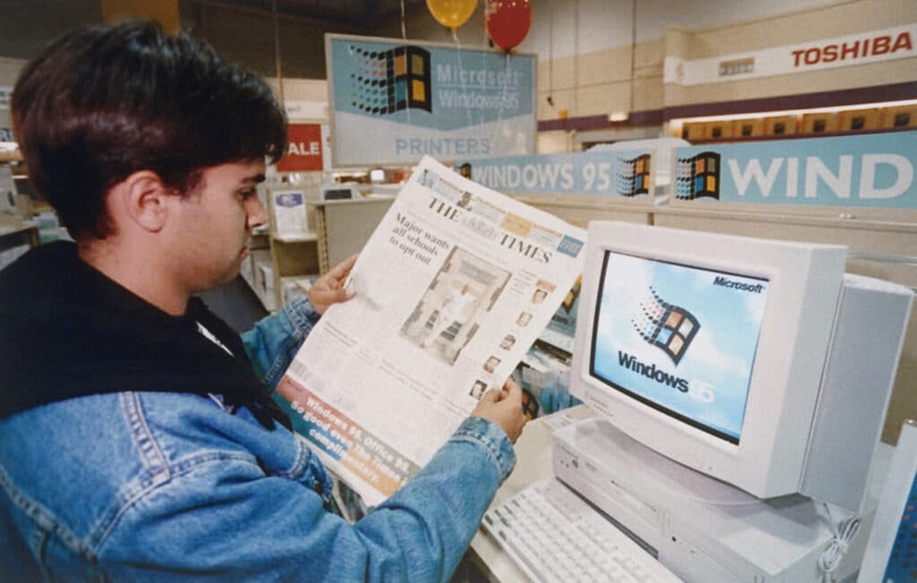 26 Nostalgic Sounds From Your Childhood That Kids Today May Never Hear Again 5 2203927869 man looking at newspaper next to windows 95 nostalgic sounds