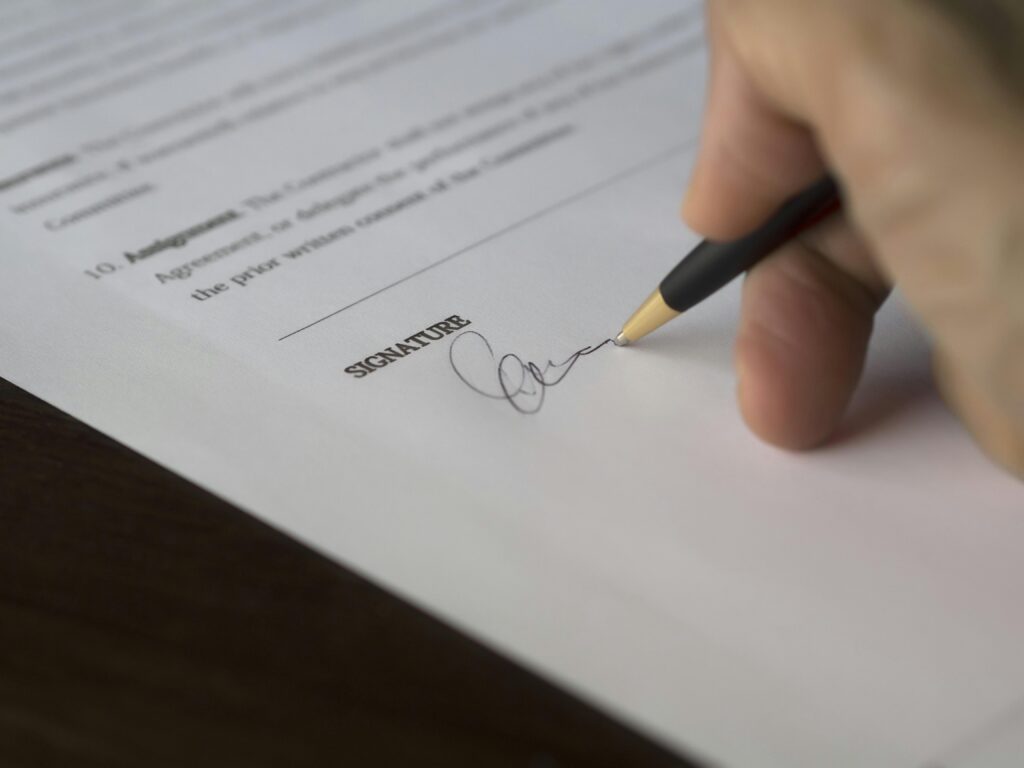 person writing signature on legal paperwork birthday wish