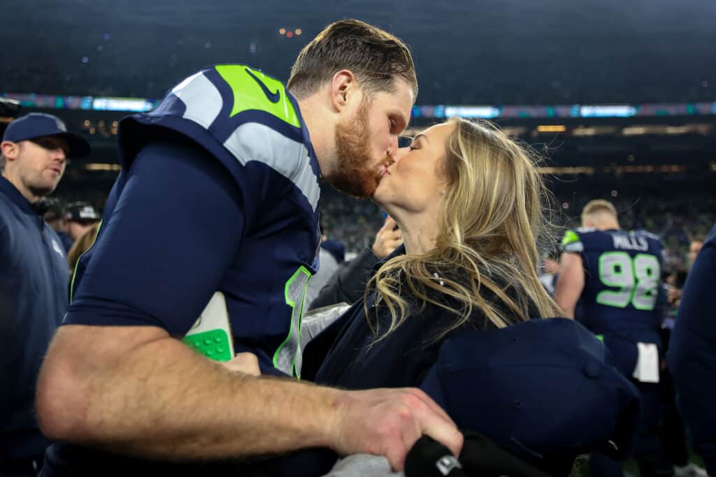 SEATTLE, WASHINGTON - JANUARY 25: Sam Darnold #14 of the Seattle Seahawks kisses his fiance Katie Hoofnagle after defeating the 31-27 in the NFC Championship game at Lumen Field on January 25, 2026 in Seattle, Washington. The Seahawks won 31-27.  (Photo by Steph Chambers/Getty Images)